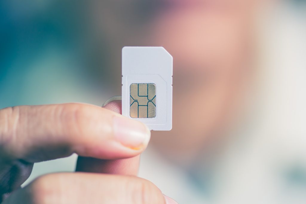 Male hand, holding SIM card